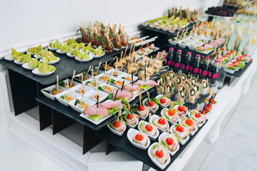 Big buffet reception of different delicious food at a wedding celebration. Snacks for guests....