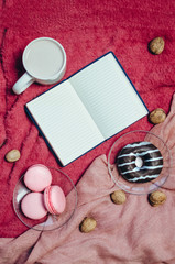 Plate with chocolate cookies, donut and cup of hot coffee on old wooden table