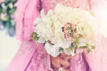 Close up bride holding bouquet of fake flower wedding