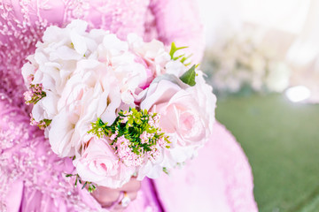 Close up bride holding bouquet of fake flower wedding