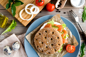 Sandwich with salmon and cheese, still life, top view, quail eggs, tomatoes.