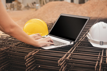 Close-up construction worker using computer helmet  on building site