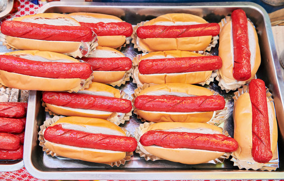 Many prepared hot dogs wrapped in a sweet bread, ready for sale at a food stand during a fiesta.Typical unhealthy cheap street food in the Philippines