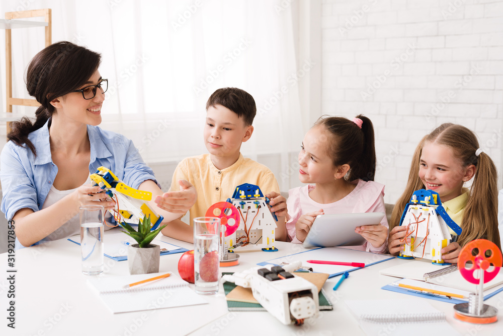 Poster teacher explaining children how to make modern robot