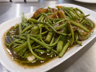 Stir-fried water mimosa with crispy pork