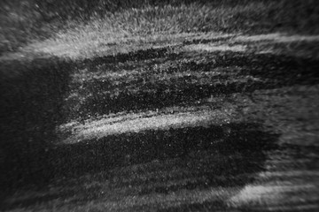 Black abstract minimalistic background. Smears of artistic ink on paper.