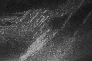 Black abstract minimalistic background. Smears of artistic ink on paper.