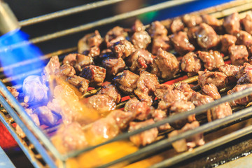 Beef Steak Dice Cooking. Grilled beef on charcoal stove and torch burn. Diced Beef Steak Japanese Style. Saikoro Steak. Asian street food. Regional Food