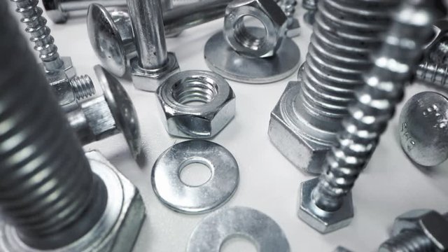 variety of metal screws and fasteners. dolly shot