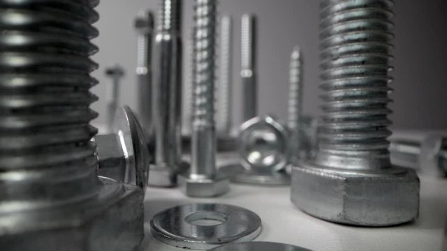 variety of metal screws and fasteners. dolly shot