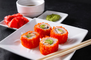 rolls with caviar on a white plate, Japanese sushi with ginger and wasabi