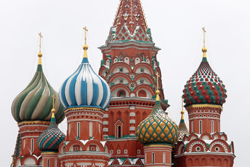 Fototapeta na wymiar St. Basil's Cathedral against the winter sky, close-up of domes covered with snow. Russian architecture landmark, located on Red square in Moscow