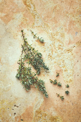Fresh thyme twigs on rustic stone background. Natural food ingredients. From above. Copy space