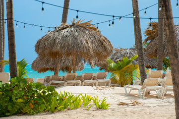 chaise longs and parasol beach on the ocean. Windy weather summer