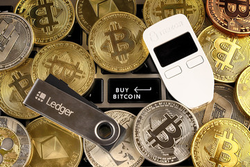 WROCLAW, POLAND - JANUARY 28, 2020: Physical version of Bitcoin (BTC), Trezor and Ledger...