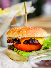 burger and french fries on wooden table. fast food