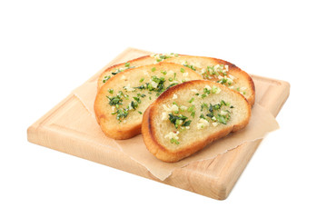 Board of toasted bread slices with garlic isolated on white background