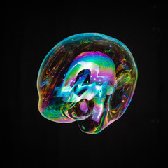 Colorful creative amorphous soap bubble floating with a black background