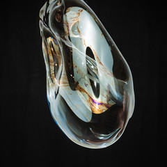 Colorful creative amorphous soap bubble floating with a black background