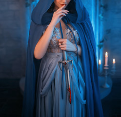 Luxury beauty elf Queen medieval royal creative clothes holds gothic dagger stained blood. Blue...