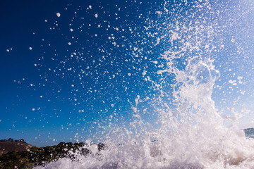 A surge of surf waves on a rocky shore