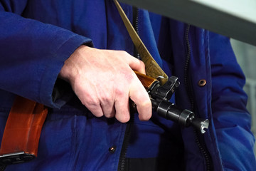 A security guards hand on a Kalashnikov. Armed departmental guards.