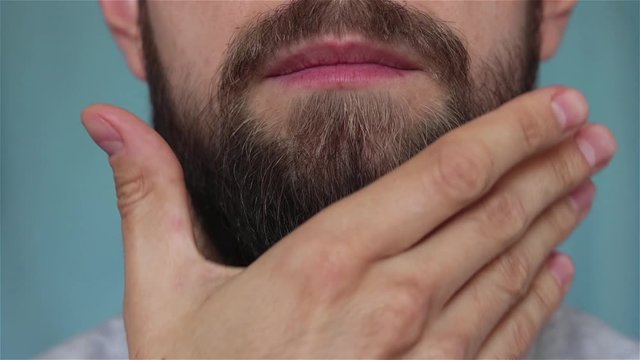 bearded man touch his bread close up