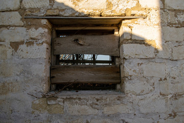 Boarded up window on an old building