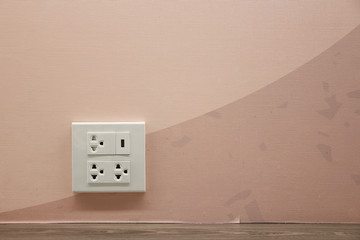 Plug Socket on the Wall with Pastel Background/Flower