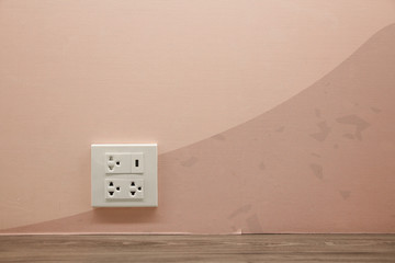 Plug Socket on the Wall with Pastel Background/Flower