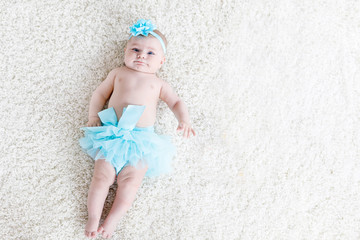 Adorable baby girl on white background wearing turquoise tutu skirt. © Irina Schmidt