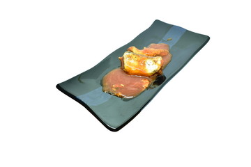 fish can with tomato sauce on plate in white background