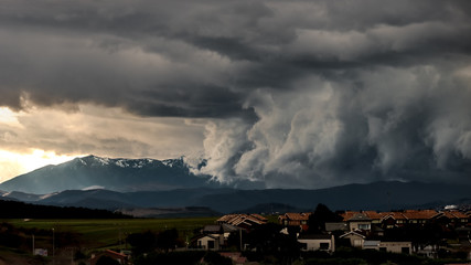 Fototapeta na wymiar Heavy storm clouds above a town