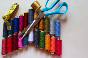 colorful spools of sewing thread on a white background