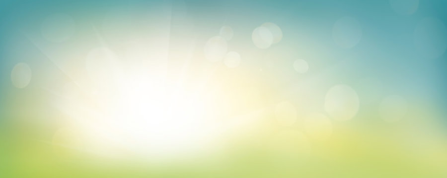 A fresh spring blue sunny sky background with blurred warm sunny glow.