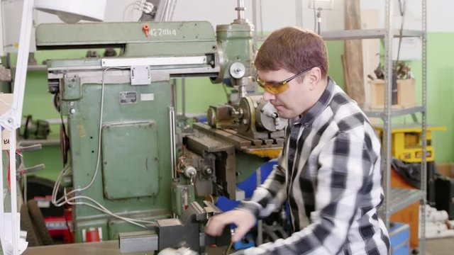 Man works circular saw. Flies of spark from hot metal. The man's hard work. Man Chlef and smooth surface
