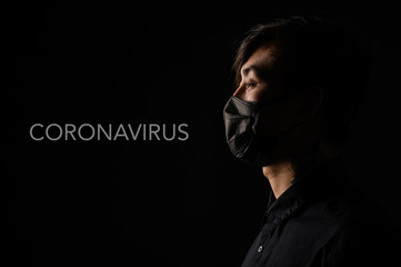 Asian man with medical face mask to protection the coronavirus. Young Asian man living in city with polluted air.
