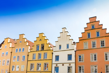 Fototapeta na wymiar colorful stepped gable houses on market square in Osnabruck, Germany
