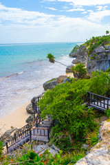 Naklejka premium Caribbean coast near Tulum. Turquoise sea and blue sky. Nature with rocks and plants. Travel photo, background. Yucatan. Quintana roo. Mexico.