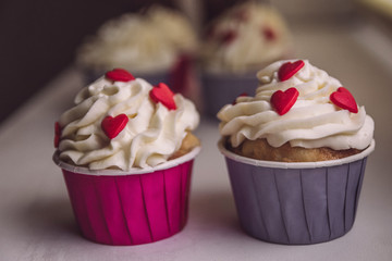 Cupcakes with cream for valentines day, decorated with hearts