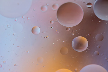 Oil drops in water. Defocused abstract psychedelic pattern image orange and gray colored. Abstract background with colorful gradient colors. DOF.