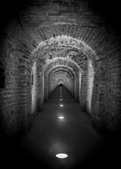 Brick tunnel archway made of red bricks as a passage between the two wings of a medieval castle....