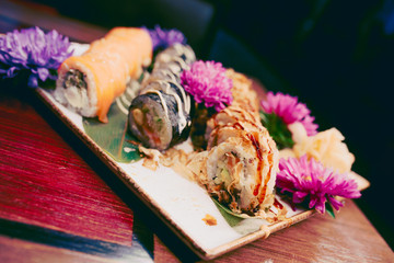 A large set of Delicious sushi rolls view from above Flat Lay . A lot assortment Philadelphia roll Dishes from Japanese raw fish  in one plate in traditional restaurant. Copy Space Japan menu service