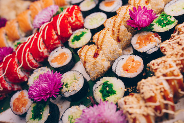 A large set of Delicious sushi rolls view from above Flat Lay . A lot assortment Philadelphia roll Dishes from Japanese raw fish  in one plate in traditional restaurant. Copy Space Japan menu service
