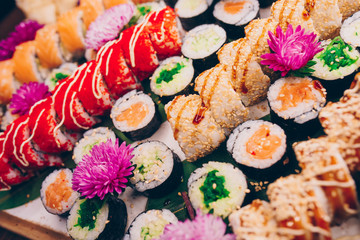 A large set of Delicious sushi rolls view from above Flat Lay . A lot assortment Philadelphia roll Dishes from Japanese raw fish  in one plate in traditional restaurant. Copy Space Japan menu service