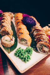 A large set of Delicious sushi rolls view from above Flat Lay . A lot assortment Philadelphia roll Dishes from Japanese raw fish  in one plate in traditional restaurant. Copy Space Japan menu service