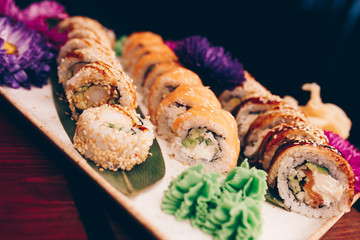 A large set of Delicious sushi rolls view from above Flat Lay . A lot assortment Philadelphia roll Dishes from Japanese raw fish  in one plate in traditional restaurant. Copy Space Japan menu service
