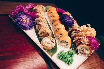 A large set of Delicious sushi rolls view from above Flat Lay . A lot assortment Philadelphia roll Dishes from Japanese raw fish  in one plate in traditional restaurant. Copy Space Japan menu service