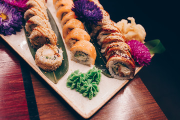 A large set of Delicious sushi rolls view from above Flat Lay . A lot assortment Philadelphia roll Dishes from Japanese raw fish  in one plate in traditional restaurant. Copy Space Japan menu service