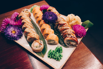 A large set of Delicious sushi rolls view from above Flat Lay . A lot assortment Philadelphia roll Dishes from Japanese raw fish  in one plate in traditional restaurant. Copy Space Japan menu service